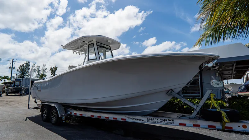  Yacht Photos Pics 2023 Tidewater 282cc Adventure Bluewater boat on trailer under blue sky.