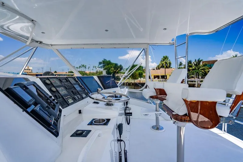 Energy Yacht Photos Pics 1998 Bertram Convertible yacht cockpit with steering wheel, control panels, and luxurious seating.