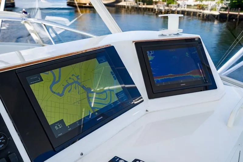 Energy Yacht Photos Pics 1998 Bertram Convertible boat dashboard with dual Garmin navigation screens, dockside view.