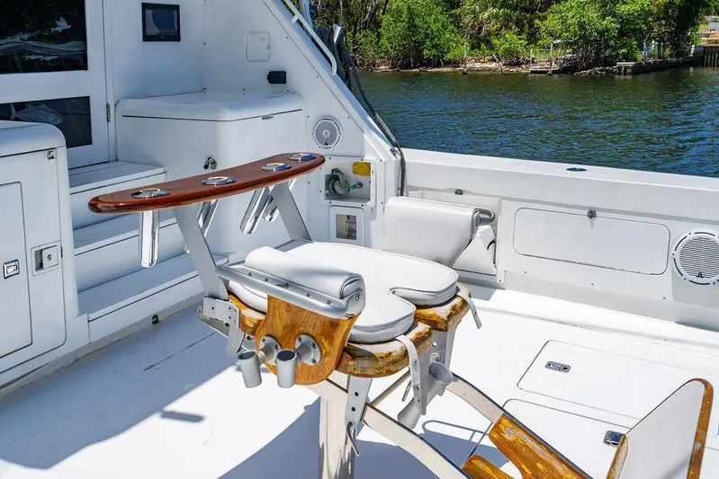 Energy Yacht Photos Pics 1998 Bertram Convertible boat interior with fishing chair, rod holders, and water view.