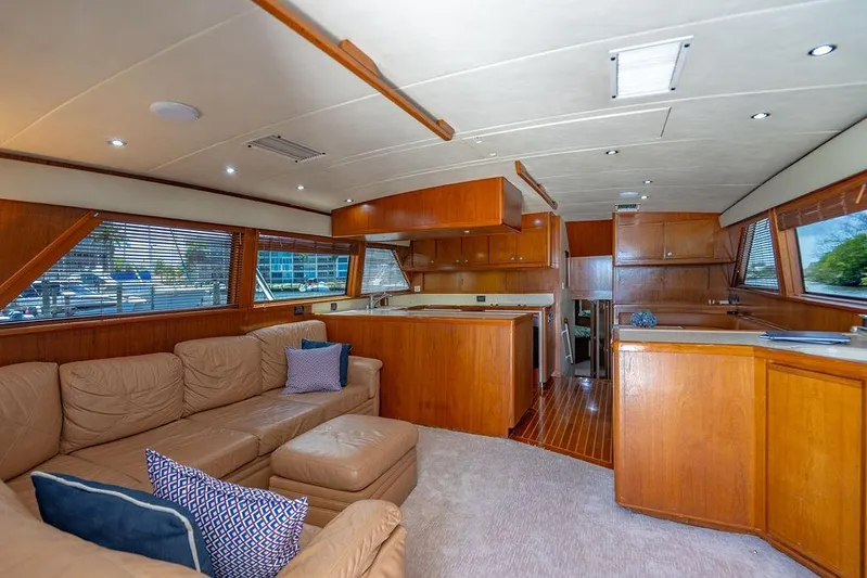 Energy Yacht Photos Pics Luxurious interior of a 1998 Bertram Convertible yacht with plush seating and wooden cabinetry.