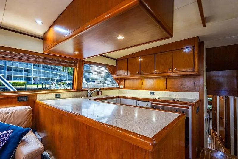 Energy Yacht Photos Pics Luxurious 1998 Bertram Convertible yacht interior with wooden cabinetry and modern kitchen amenities.