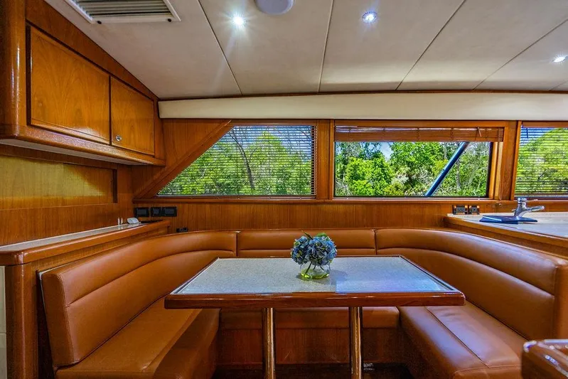 Energy Yacht Photos Pics Luxurious interior of a 1998 Bertram Convertible yacht with leather seating and wooden finishes.