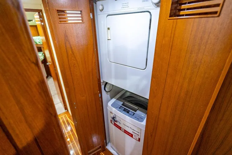 Energy Yacht Photos Pics Laundry area inside 1998 Bertram Convertible yacht with wooden cabinetry.