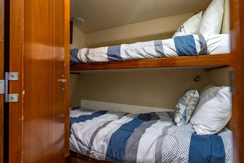 Energy Yacht Photos Pics Bunk beds in a 1998 Bertram Convertible yacht cabin with striped bedding.