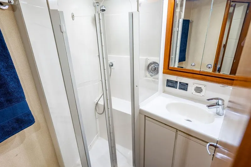 Energy Yacht Photos Pics Compact bathroom in a 1998 Bertram Convertible yacht with shower and sink.