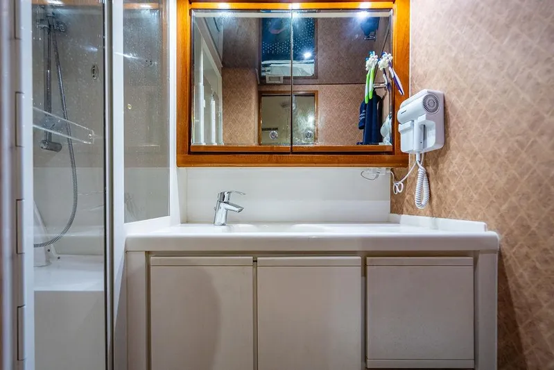 Energy Yacht Photos Pics Bathroom interior of 1998 Bertram Convertible yacht with shower and vanity.