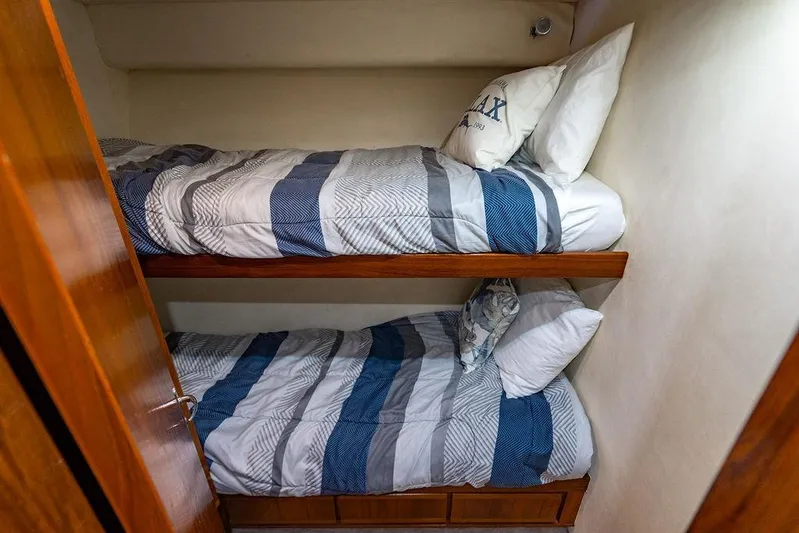 Energy Yacht Photos Pics Bunk beds in a 1998 Bertram Convertible yacht cabin with striped bedding.