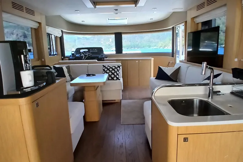  Yacht Photos Pics Luxurious interior of 2022 Sirena 58 yacht with modern kitchen and seating area.