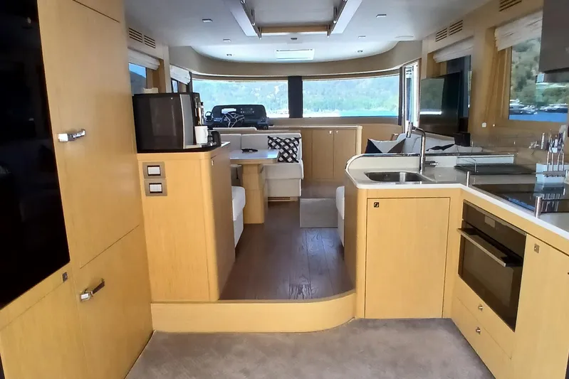  Yacht Photos Pics Luxurious interior of 2022 Sirena 58 yacht with modern kitchen and seating area.