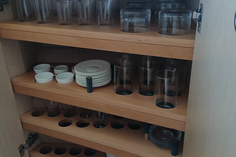  Yacht Photos Pics Wooden cabinet with neatly organized glassware and dishes, Sirena 58, 2022 model.