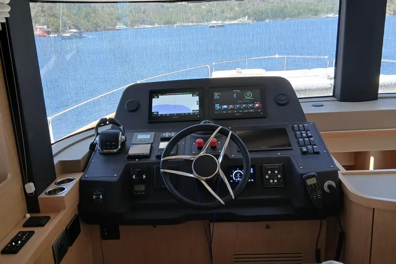  Yacht Photos Pics Helm of 2022 Sirena 58 yacht with modern navigation equipment and scenic ocean view.