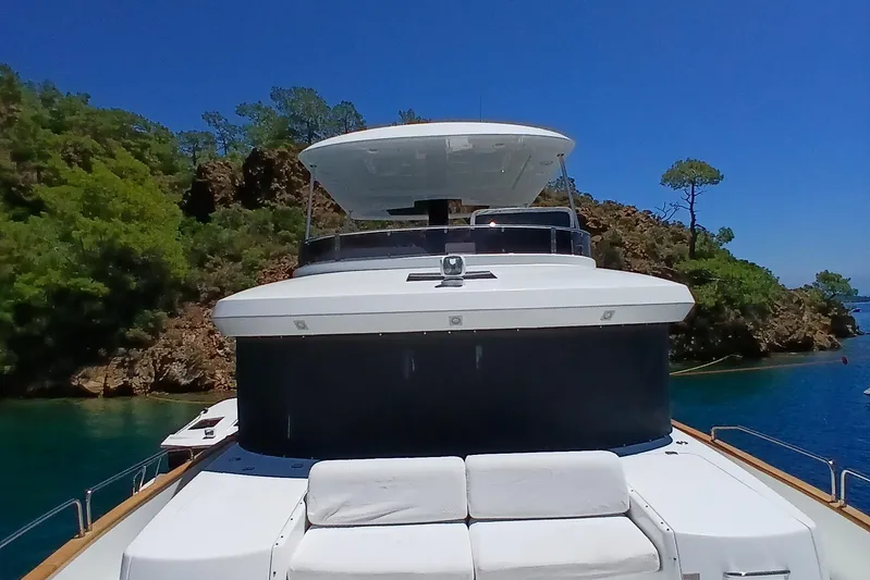  Yacht Photos Pics 2022 Sirena 58 yacht docked in a scenic, lush coastal area.