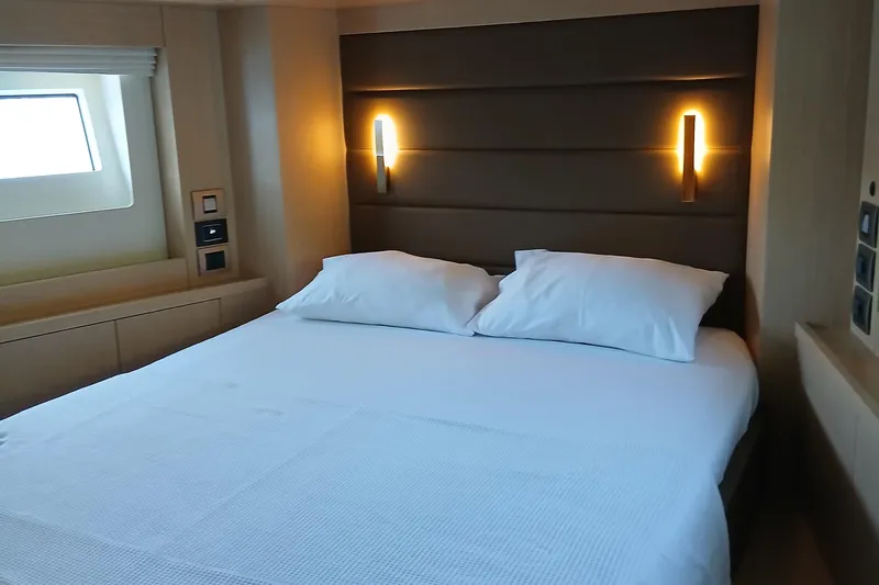  Yacht Photos Pics Luxurious cabin interior of 2022 Sirena 58 yacht with cozy bed and ambient lighting.