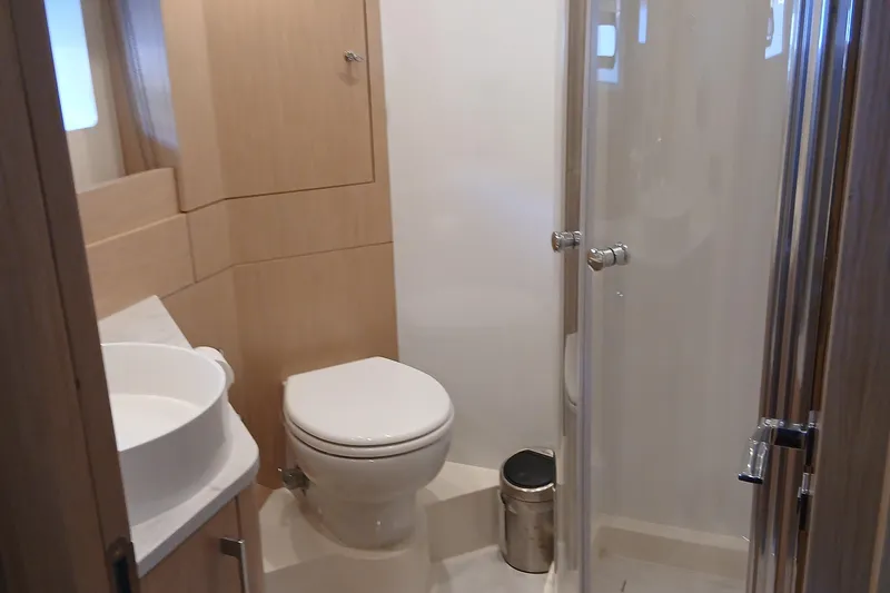  Yacht Photos Pics Modern bathroom in 2022 Sirena 58 yacht with shower, toilet, and sink.