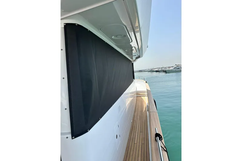  Yacht Photos Pics Side view of 2022 Sirena 58 yacht with wooden deck and black sunshade.