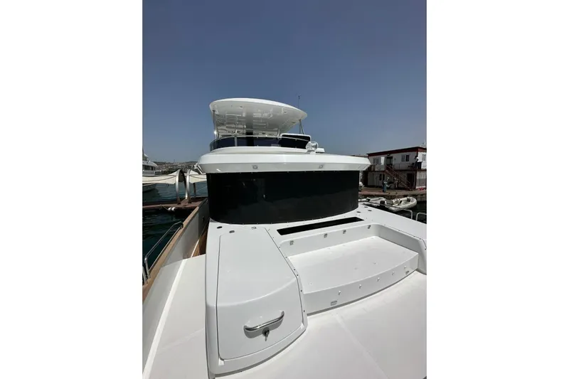  Yacht Photos Pics 2022 Sirena 58 yacht docked, showcasing sleek design and modern features under clear skies.