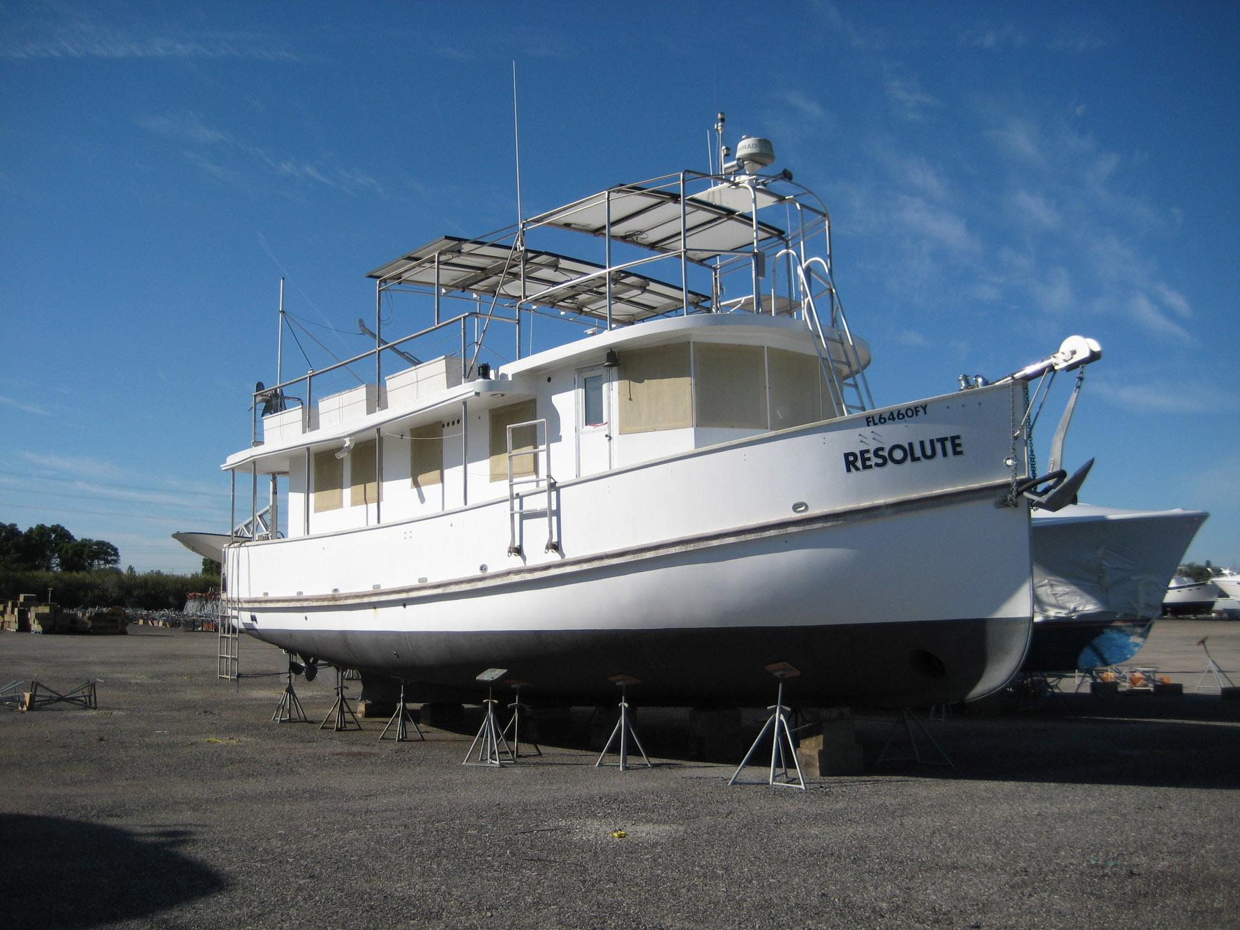 Custom 1987 Pilgrim Tribute boat "Resolute" on dry dock under clear blue sky.