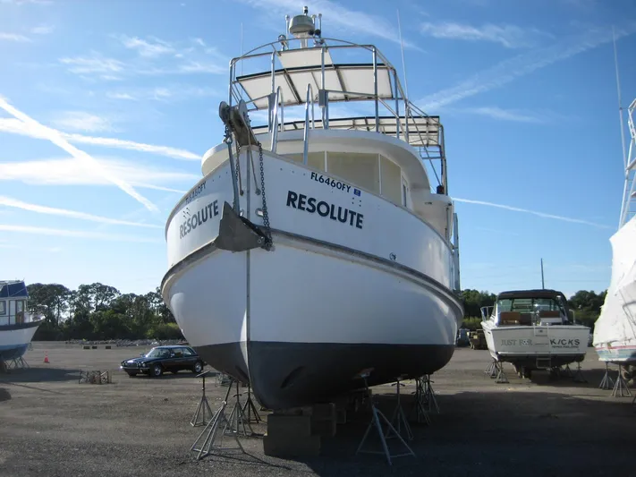 Resolute Yacht Photos Pics Custom 1987 Pilgrim Tribute boat "Resolute" on dry dock, clear sky background.