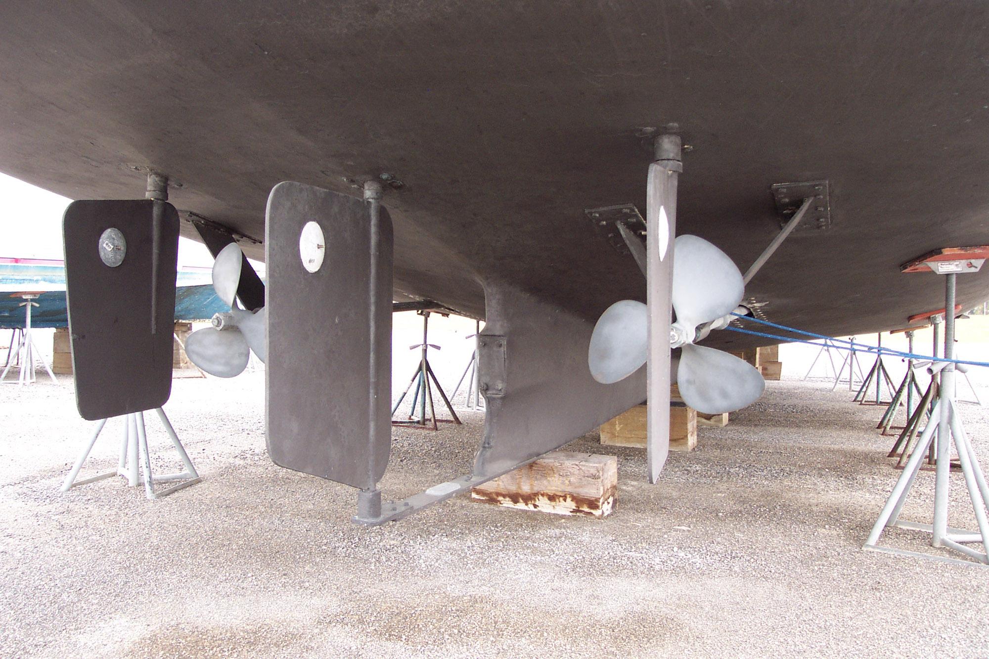 Underside view of 1987 Custom Pilgrim Tribute boat with dual propellers and rudders.