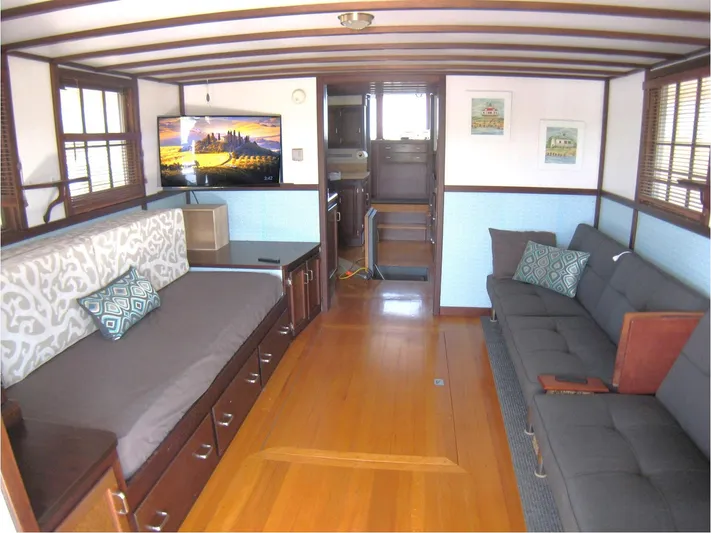 Resolute Yacht Photos Pics Interior of 1987 Custom Pilgrim Tribute boat with modern furnishings and wooden flooring.