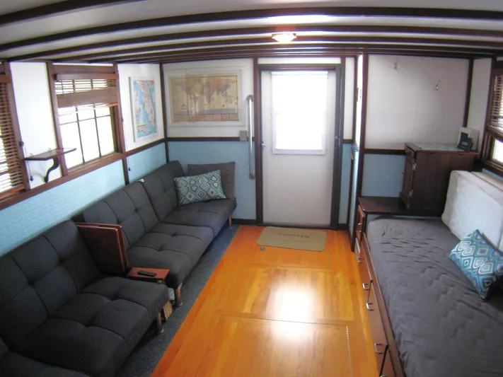 Resolute Yacht Photos Pics Interior of 1987 Custom Pilgrim Tribute boat with cozy seating and wooden flooring.