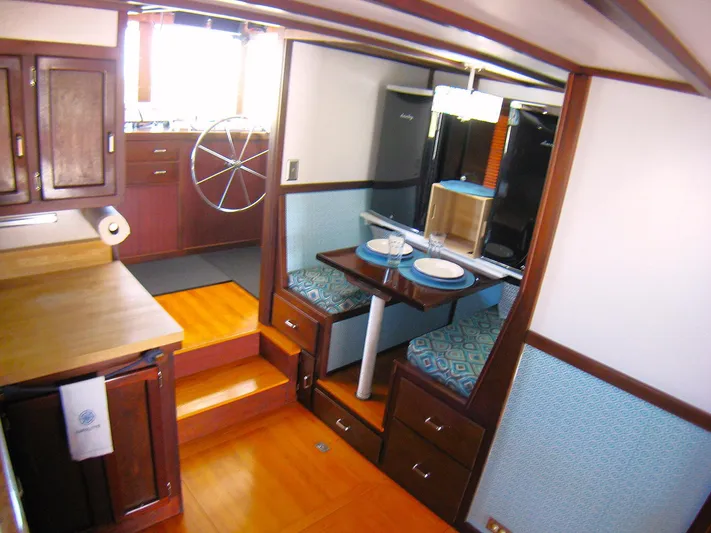 Resolute Yacht Photos Pics Interior of 1987 Custom Pilgrim Tribute boat with dining area and kitchen.