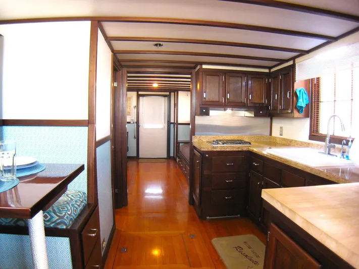 Resolute Yacht Photos Pics Interior of 1987 Custom Pilgrim Tribute boat with wooden cabinetry and modern kitchen amenities.
