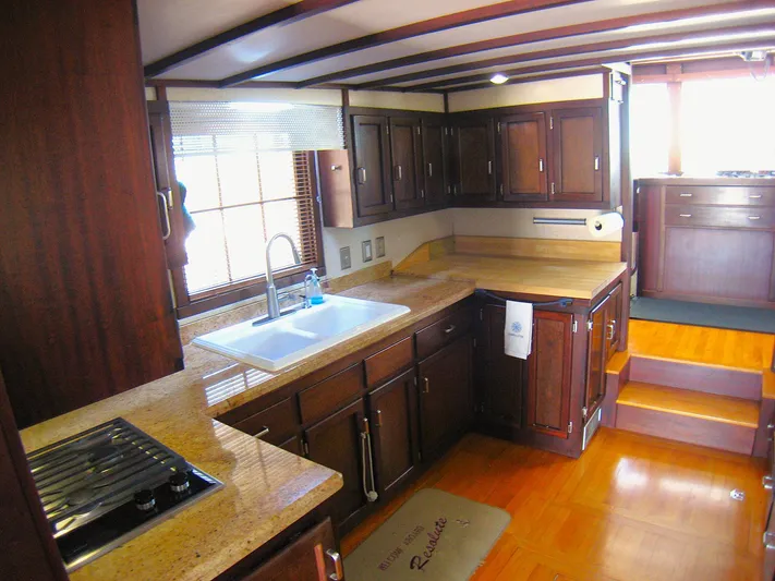 Resolute Yacht Photos Pics Spacious kitchen in 1987 Custom Pilgrim Tribute boat with wooden cabinets and countertops.