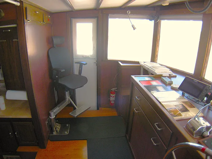 Resolute Yacht Photos Pics 1987 Custom Pilgrim Tribute boat interior with control panel and captain's chair.