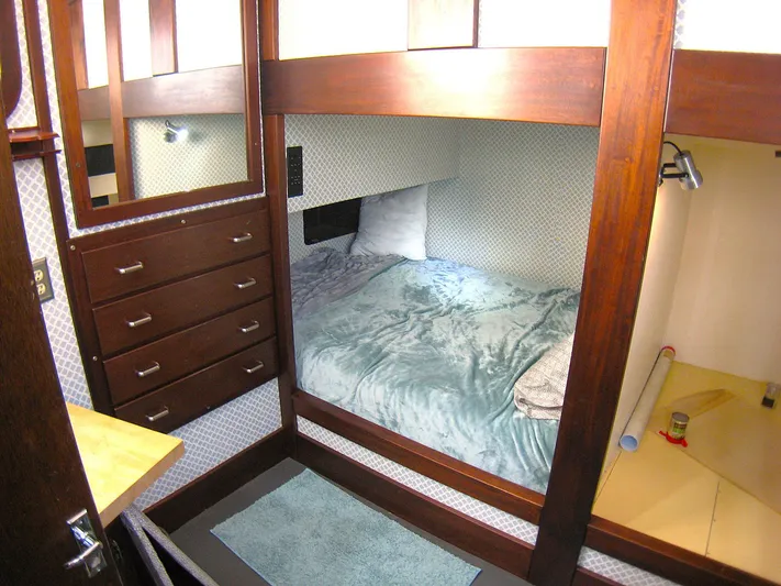 Resolute Yacht Photos Pics Cozy cabin interior of 1987 Custom Pilgrim Tribute with bed, drawers, and wood accents.