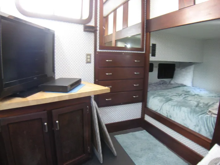 Resolute Yacht Photos Pics Interior of 1987 Custom Pilgrim Tribute with TV, bunk bed, and wooden cabinetry.