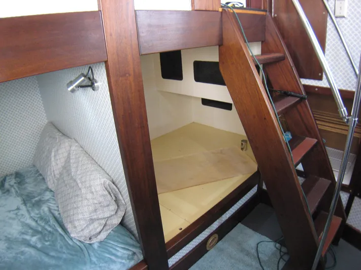 Resolute Yacht Photos Pics Interior of 1987 Custom Pilgrim Tribute boat with wooden bunk beds and stairs.