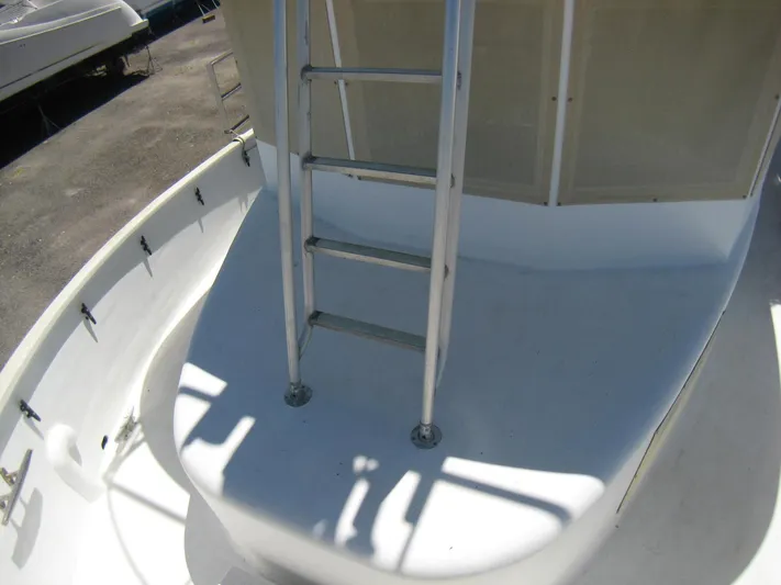 Resolute Yacht Photos Pics 1987 Custom Pilgrim Tribute boat deck with ladder, showcasing sleek white design.