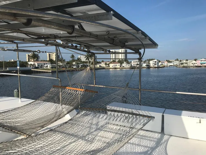 Resolute Yacht Photos Pics Hammocks on a 1987 Custom Pilgrim Tribute boat overlooking a serene waterfront view.