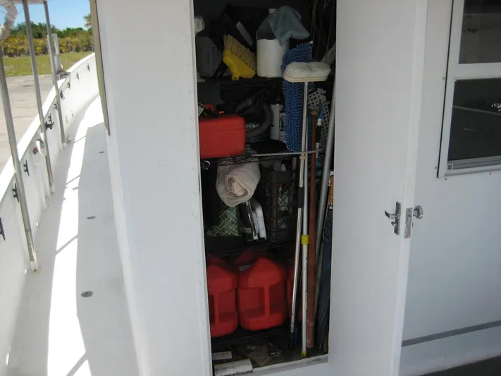 Resolute Yacht Photos Pics Storage compartment on 1987 Custom Pilgrim Tribute boat, filled with various equipment and supplies.