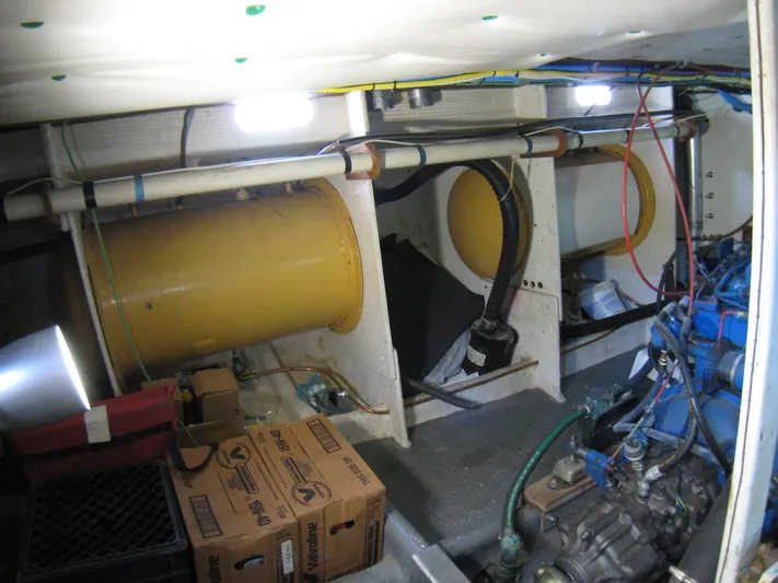 Resolute Yacht Photos Pics Engine room of 1987 Custom Pilgrim Tribute boat with visible machinery and storage boxes.