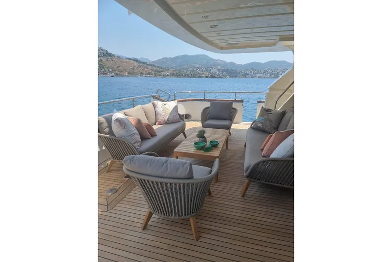  Yacht Photos Pics Luxurious Falcon 90 yacht deck with elegant seating, overlooking serene blue waters, 2011 model.