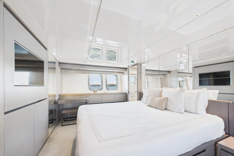  Yacht Photos Pics Luxurious bedroom interior of 2018 Sanlorenzo SL86 yacht with modern design and large windows.
