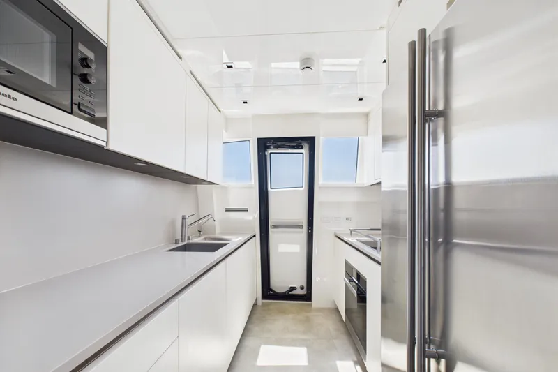  Yacht Photos Pics Modern kitchen interior on 2018 Sanlorenzo SL86 yacht, featuring sleek white cabinetry and stainless steel appliances.