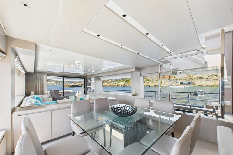  Yacht Photos Pics Luxurious interior of 2018 Sanlorenzo SL86 yacht with glass dining table and panoramic windows.