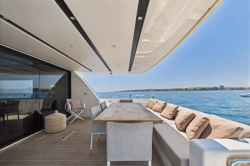  Yacht Photos Pics Luxury Sanlorenzo SL86 yacht deck with dining area, ocean view, and comfortable seating, 2018 model.