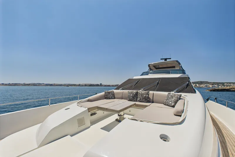  Yacht Photos Pics Sanlorenzo SL86 2018 yacht with luxurious deck seating, cruising on a clear blue sea.