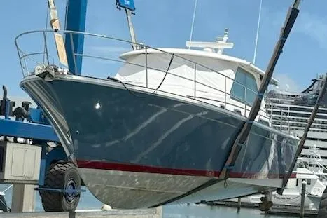  Yacht Photos Pics 2022 Sabre 45 Salon Express yacht in dry dock, blue hull, white cabin.