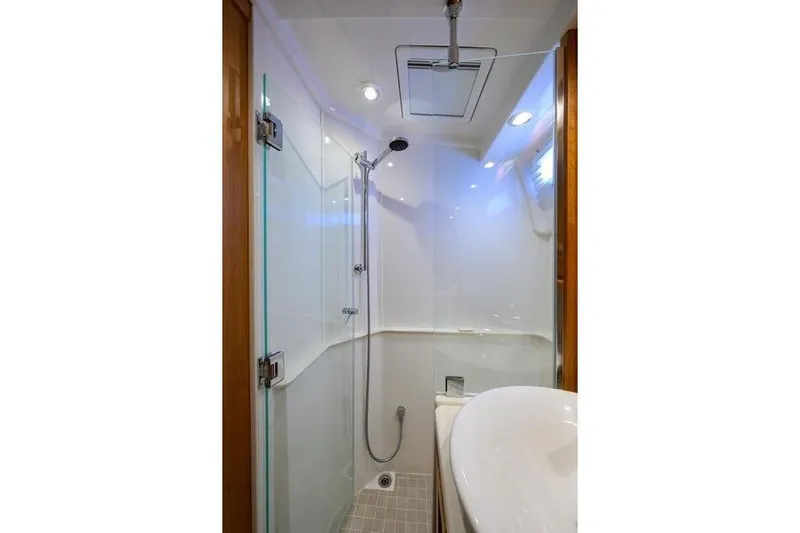  Yacht Photos Pics 2022 Sabre 45 Salon Express bathroom with modern shower and sleek design.