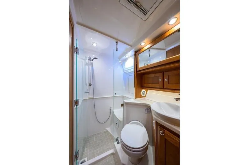  Yacht Photos Pics Luxurious bathroom in 2022 Sabre 45 Salon Express yacht with shower and wooden cabinetry.