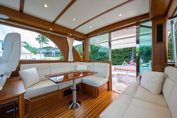  Yacht Photos Pics Luxurious interior of 2022 Sabre 45 Salon Express yacht with elegant seating and wooden finishes.