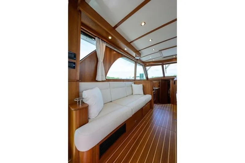  Yacht Photos Pics Interior of 2022 Sabre 45 Salon Express yacht with elegant wood finish and white seating.