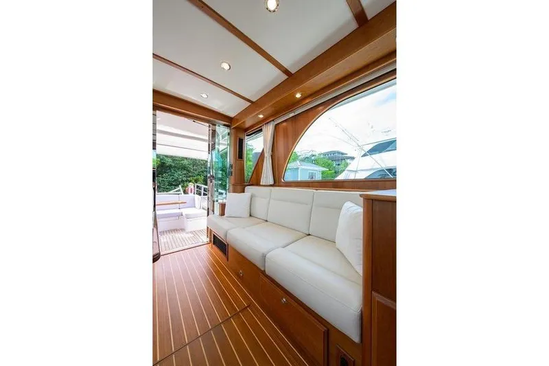  Yacht Photos Pics Interior of 2022 Sabre 45 Salon Express yacht with elegant wood and white seating.