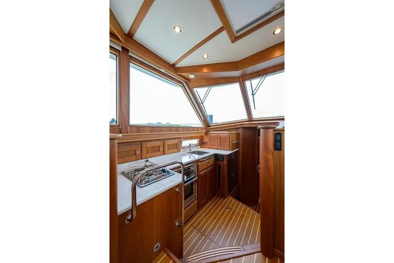  Yacht Photos Pics 2022 Sabre 45 Salon Express yacht interior with wood finish and modern kitchen.